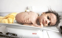 A malnourished child lies on a weighing machine at a therapeutic feeding Centre at Al Sabyeen hospital in Sana’a. (Reuters)